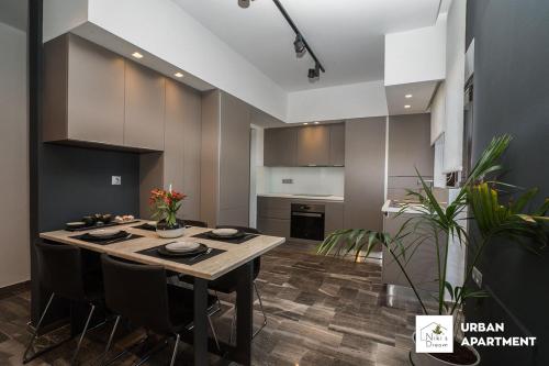 a kitchen with a table and chairs in a room at Nikis Dream Luxury Apartments in Chania