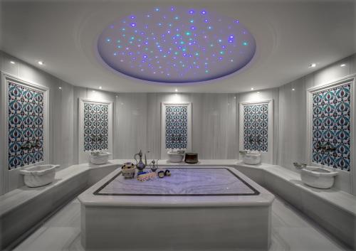 a bathroom with a large tub with a large ceiling at Movenpick Diyarbakir in Diyarbakır