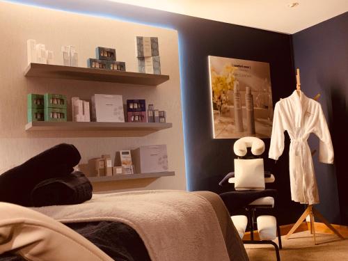 a bedroom with a bed and shelves with books at Bayview Hotel in Bushmills