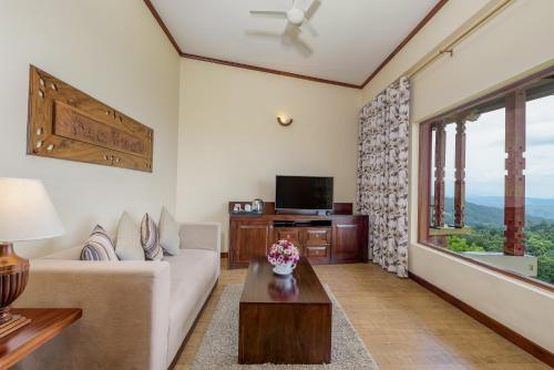 a living room filled with furniture and a tv at Amaya Hills Kandy in Kandy