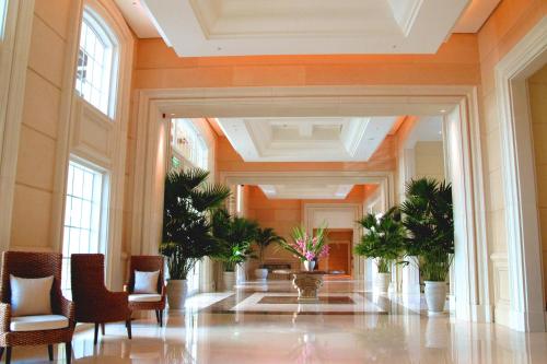 a hallway with chairs and plants in a building at RSL Cold & Hot Springs Resort Suao in Suao