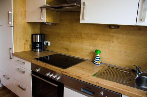 a kitchen with a sink and a counter top at Ferienhaus Paula in Hooksiel