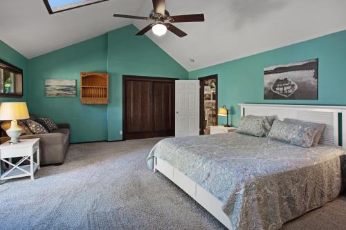 a bedroom with a bed and a ceiling fan at Fort Bragg Farmhouse in Fort Bragg