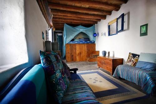 a living room with a couch and a bed at Clive and Bifi's house in Lakhania