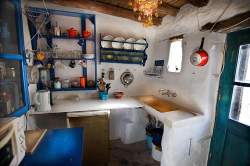 a small kitchen with a counter and a sink at Clive and Bifi's house in Lachania