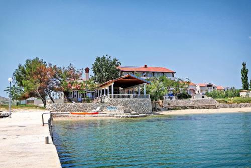 a house on the shore of a body of water at Guesthouse Dupin in Vlašići