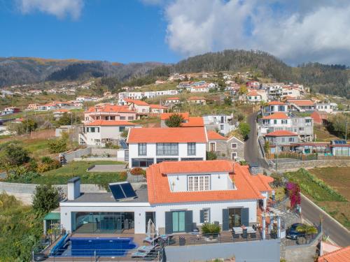 an aerial view of a house with an orange roof at Casa Lira in Arco da Calheta