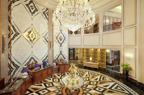 a lobby with a chandelier and a large room at Silk Path Grand Sapa Resort & Spa in Sa Pa