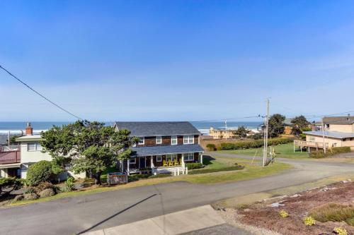 an aerial view of a house with the ocean in the background at The Lucky Starfish in Lincoln City