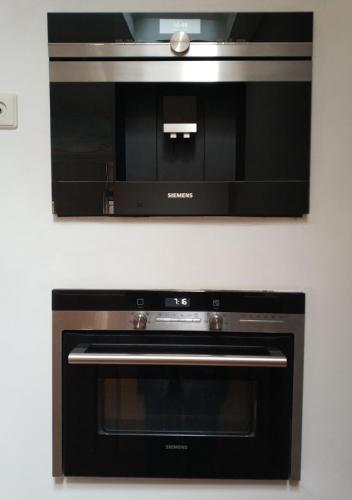 a black oven with a microwave on a wall at Pearl of the Hague - R.Q.C. in The Hague