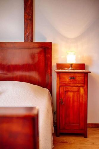 a bedroom with a bed and a lamp on a wooden cabinet at Apartment Domina in Vis
