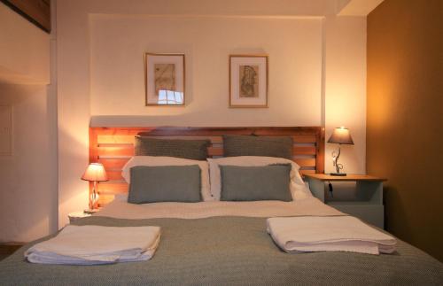 a bedroom with a large bed with two pillows at Pike Cliffs I in Prainha de Cima