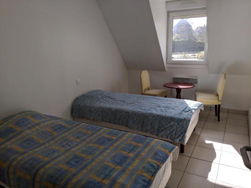 Łóżko lub łóżka w pokoju w obiekcie Le gîte de Magaly