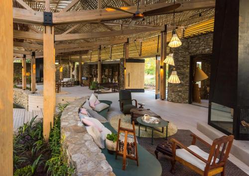 a living room with couches and chairs and a table at Saseka Tented Camp in Hoedspruit