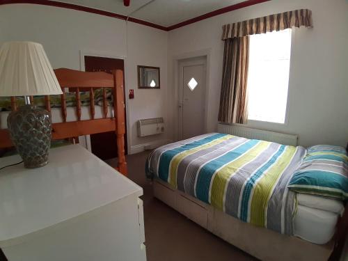 Ένα ή περισσότερα κρεβάτια σε δωμάτιο στο Rosemede Holiday Flats