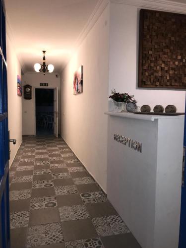 a hallway with a counter and a tile floor at Halikarnas Pansiyon in Bodrum City