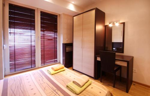 a kitchen with a desk and a table with a chair at Apartments Belgrade in Belgrade