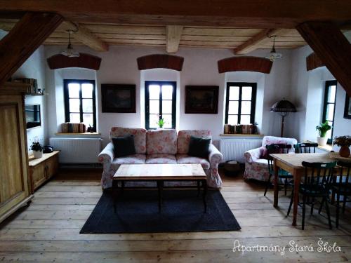 a living room with a couch and a table at Apartmány Stará Škola in Krásná Lípa