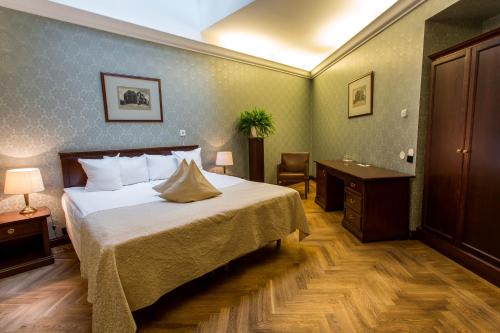 a hotel room with a bed and a desk at Hestia Hotel Barons Old Town in Tallinn