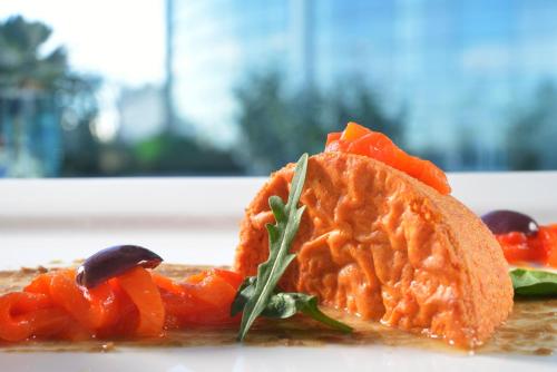 a plate of food with carrots and other vegetables at Hotel Diamante in Alessandria