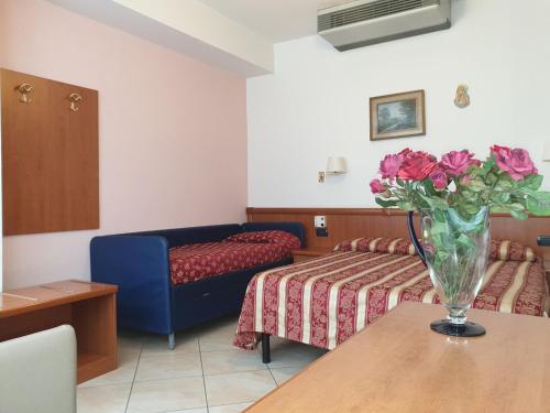 Postel nebo postele na pokoji v ubytování Hotel Ginevra