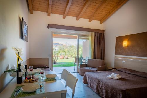 a room with a bed and a table and a couch at Agriturismo Tre Colline in Bardolino