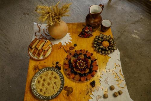 a wooden table with food and other items on it at Ashtarak Garden GuestHouse in Ashtarak
