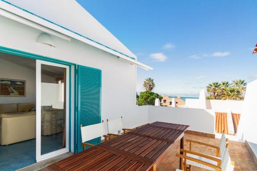 a view from the balcony of a house with a table and chairs at Liiiving in Algarve - Alvor Blue Villa in Alvor