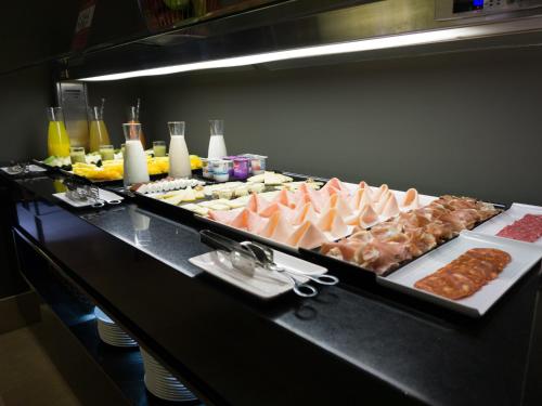 a buffet line with many different types of food at Carris Cardenal Quevedo in Ourense