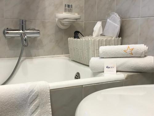 a bathroom with a toilet and a bath tub with towels at Moonlight- Bedbluesky in Perinaldo