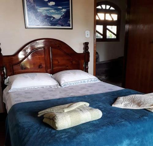 a bed with two pillows on top of it at Jardim das orquídeas in Mucugê