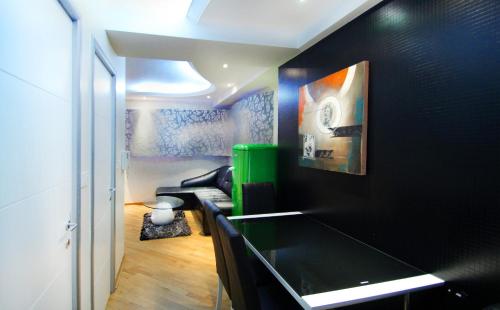 a living room with a black wall and a couch at Apartments Belgrade in Belgrade