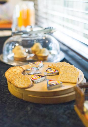 a tray of crackers and cookies on a table at Amper Bo Guest House in Pretoria