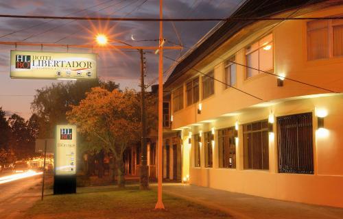 a building with a sign on the side of a street at Hotel Libertador Bernardo O´Higgins in Chillán