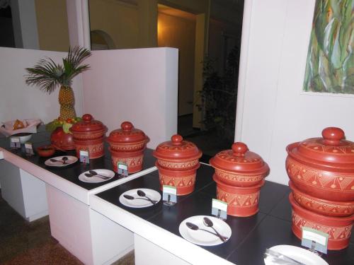 a room with red containers and plates on a counter at Sanmali Beach Hotel in Marawila