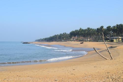 a beach with a sign in the sand at Sanmali Beach Hotel in Marawila