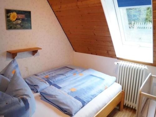 a small bed in a room with a window at Klausseppenhof in Oberwolfach