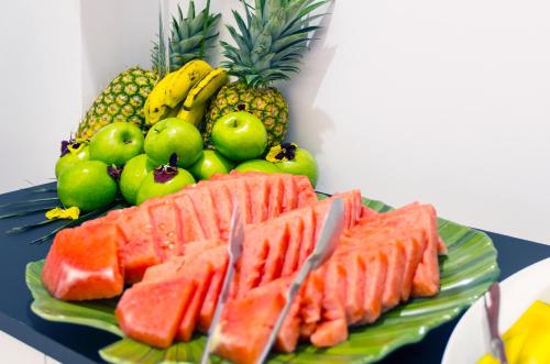 a plate of food with fruit on a table at Reverence Life Hotel - Adults Only in Santa Ponsa