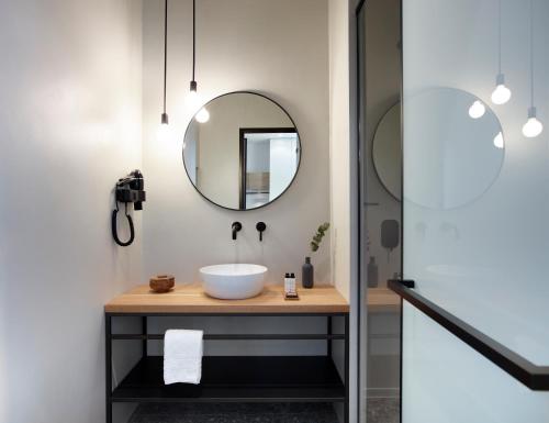 a bathroom with a sink and a mirror at InnAthens in Athens