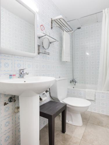 a bathroom with a sink and a toilet at Hostal - Pensión El Amigo in Lloret de Mar