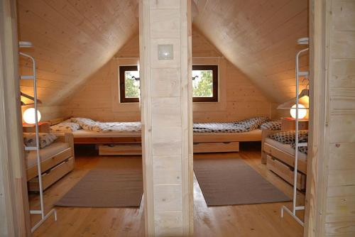 a room with bunk beds in a wooden cabin at Mountain chalet SmoLenisko domek w górach in Nowy Targ
