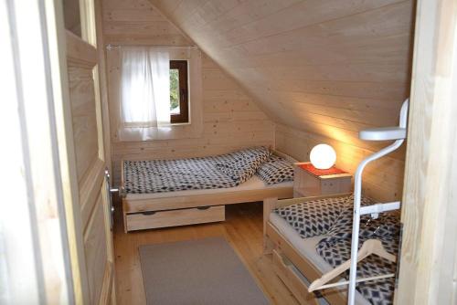 a small room with two beds and a window at Mountain chalet SmoLenisko domek w górach in Nowy Targ