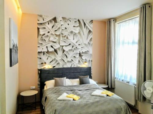 a bedroom with a bed with two towels on it at Pension SKLEP in Prague