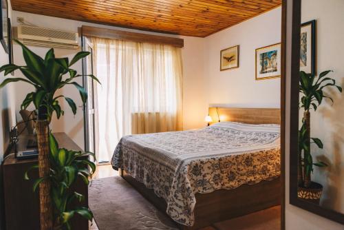 a bedroom with a bed and a large window at El Mar Apartments in Budva