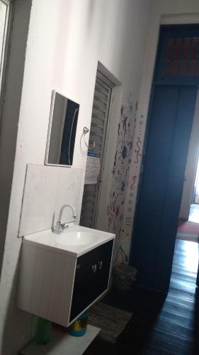a bathroom with a sink and a mirror at Hostel Torre Bahia in Salvador