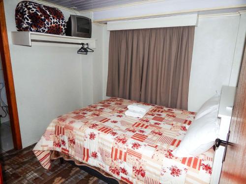 Cama o camas de una habitación en Gramado Suites Residence possui 5 quartos e 5 banheiros