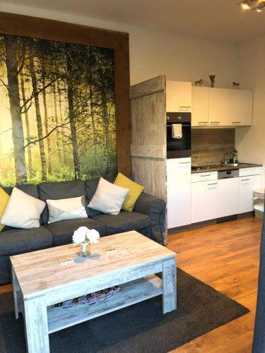 a living room with a couch and a table at Willow Court Farm Studio West & Petting Farm, 8 mins to Legoland & Windsor, 15 mins to Lapland UK in Windsor