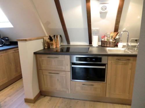 a kitchen with a sink and a stove at Gîte FLEUR DE VIGNES in Itterswiller