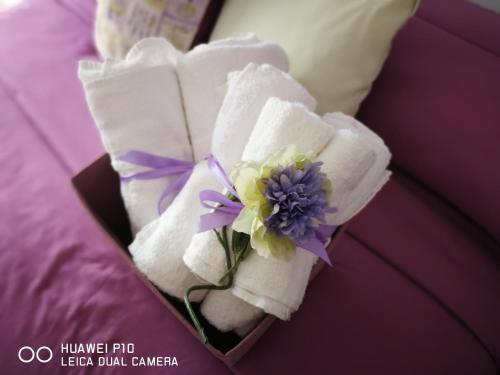 a bouquet of towels and a flower on a bed at Dimora Fraula Guest House in Agrigento