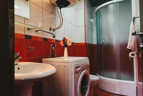 a bathroom with a sink and a toilet and a shower at El Mar Apartments in Budva